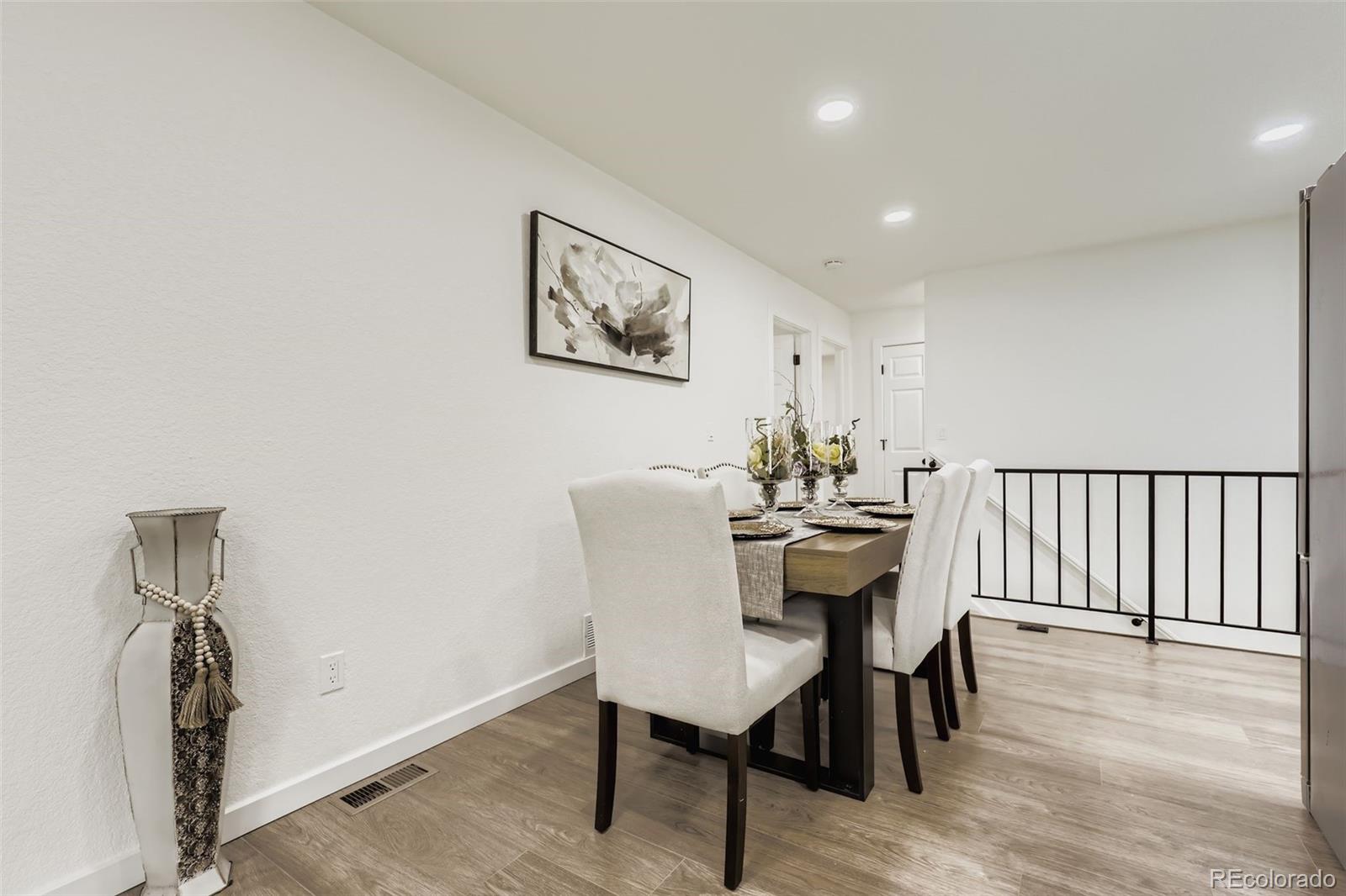 4465 Durham Court Denver, CO 80239 - Photo 13 of 28 a view of a dining room with furniture and wooden floor