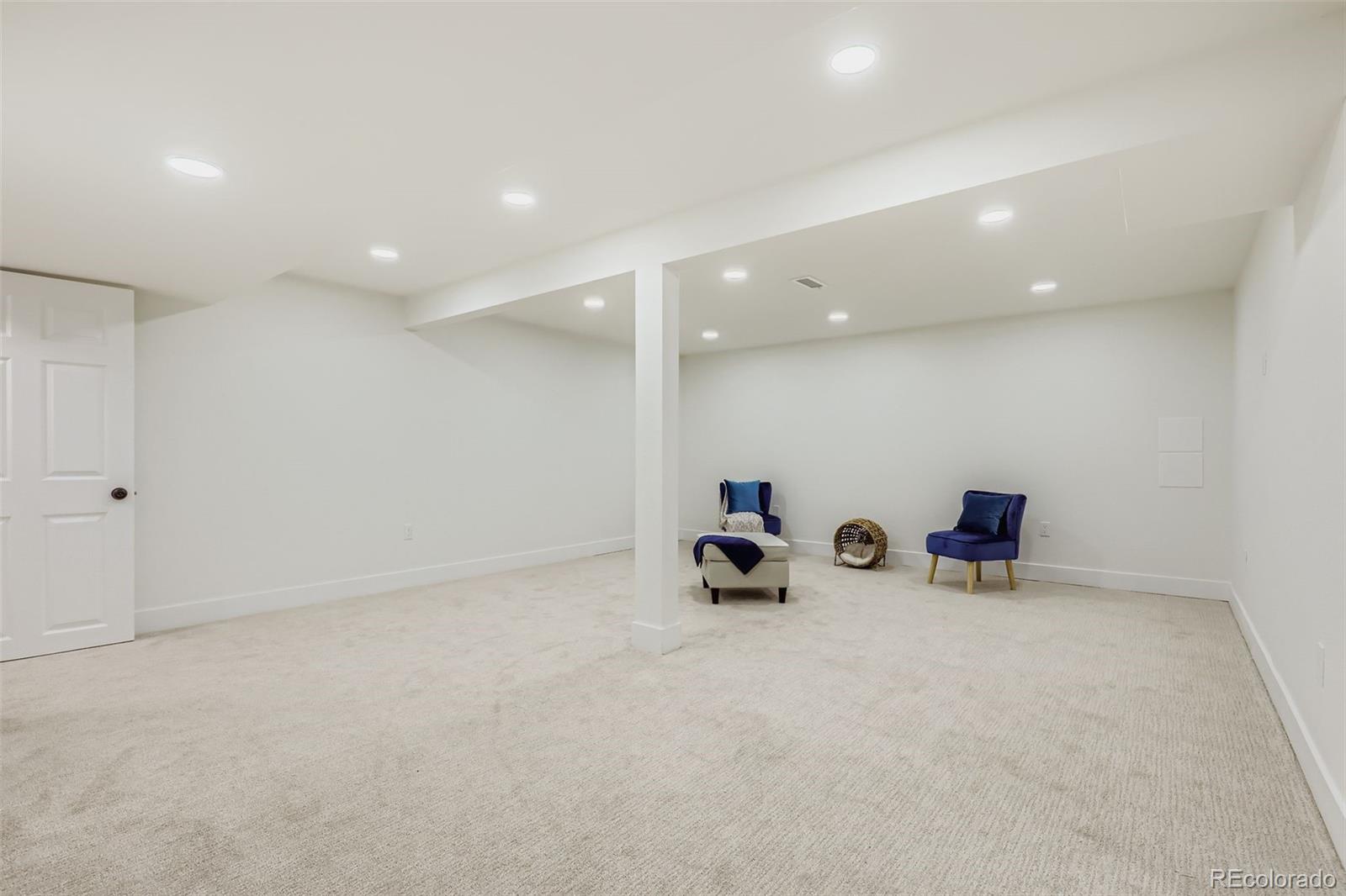 4465 Durham Court Denver, CO 80239 - Photo 20 of 28 an empty room with white wall and couches