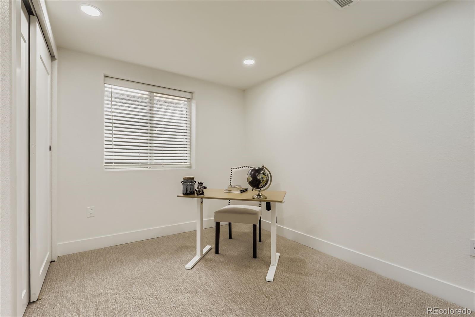 4465 Durham Court Denver, CO 80239 - Photo 23 of 28 a workspace with furniture and a window