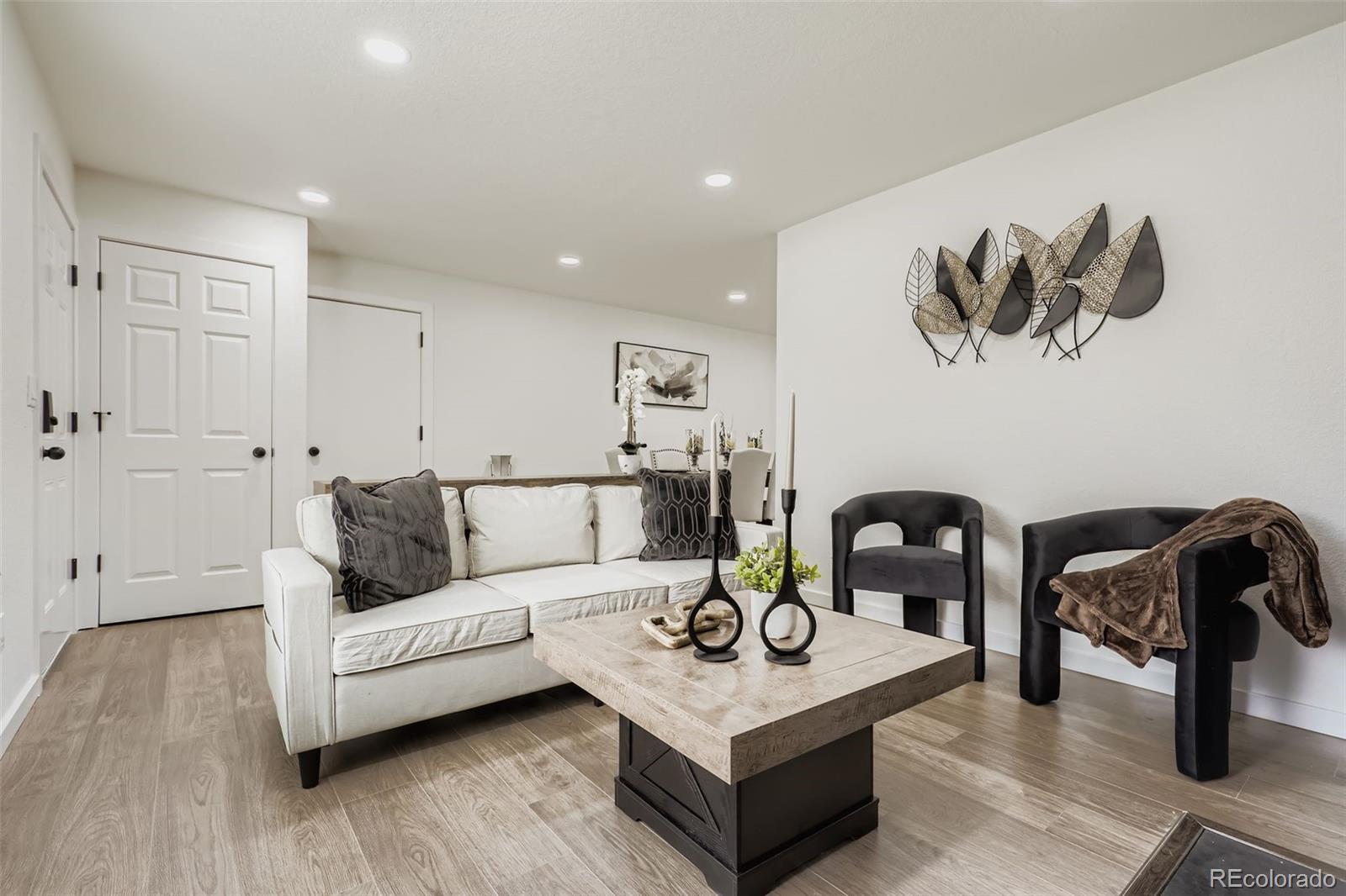4465 Durham Court Denver, CO 80239 - Photo 5 of 28 a living room with furniture and wooden floor