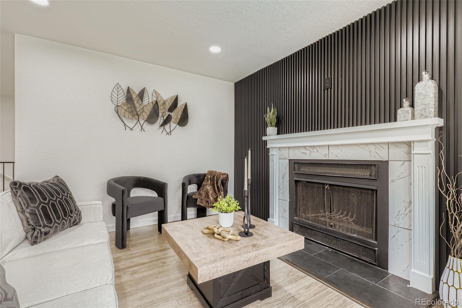 4465 Durham Court Denver, CO 80239 - Photo 6 of 28 a living room with furniture and a fireplace