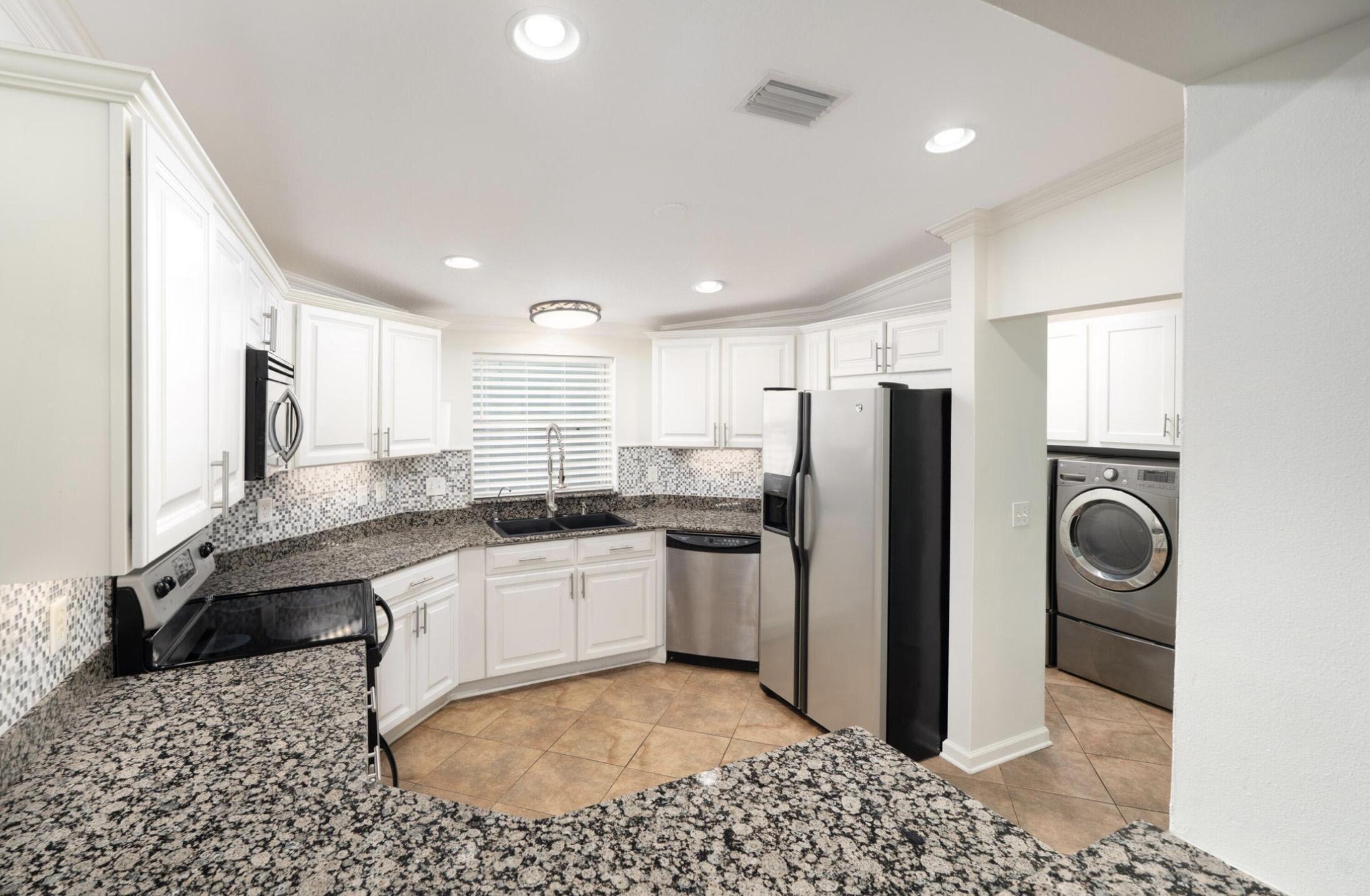 237 Monarch Drive Santa Rosa Beach, FL 32459 - Photo 10 of 30 a kitchen with a sink a refrigerator and cabinets
