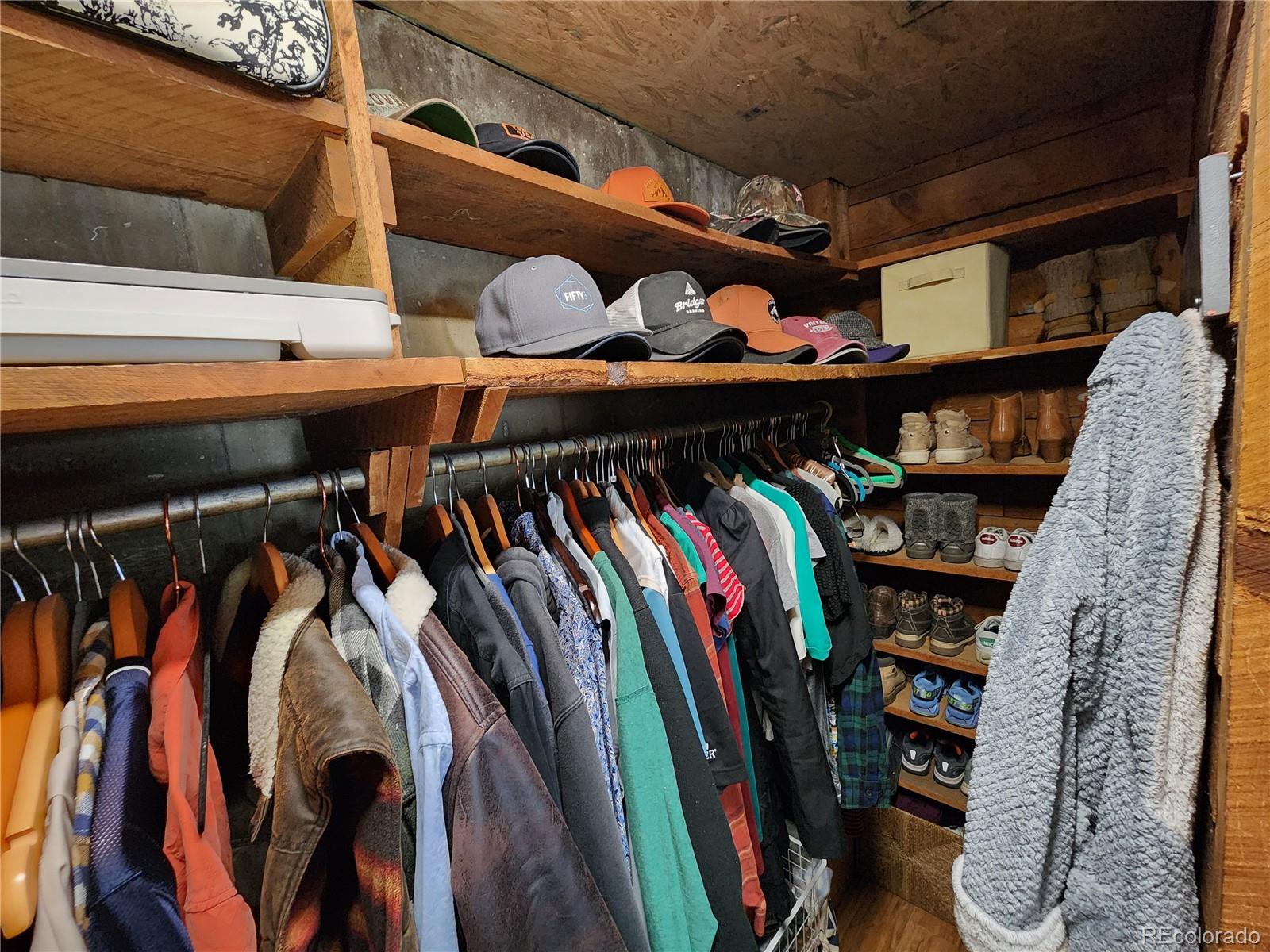 388 Clark Road Bailey, CO 80421 - Photo 23 of 50 a view of walk in closet with clothes and shoes