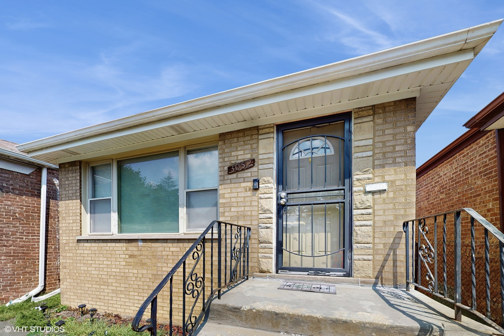 3052 East 97th Street Chicago, IL 60617 - Photo 1 of 19 a front view of a house with large windows