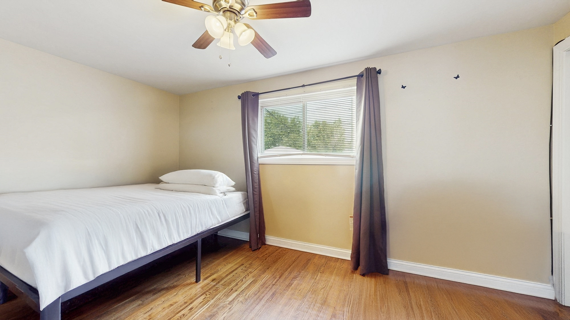 3052 East 97th Street Chicago, IL 60617 - Photo 11 of 19 a bedroom with a bed and a window