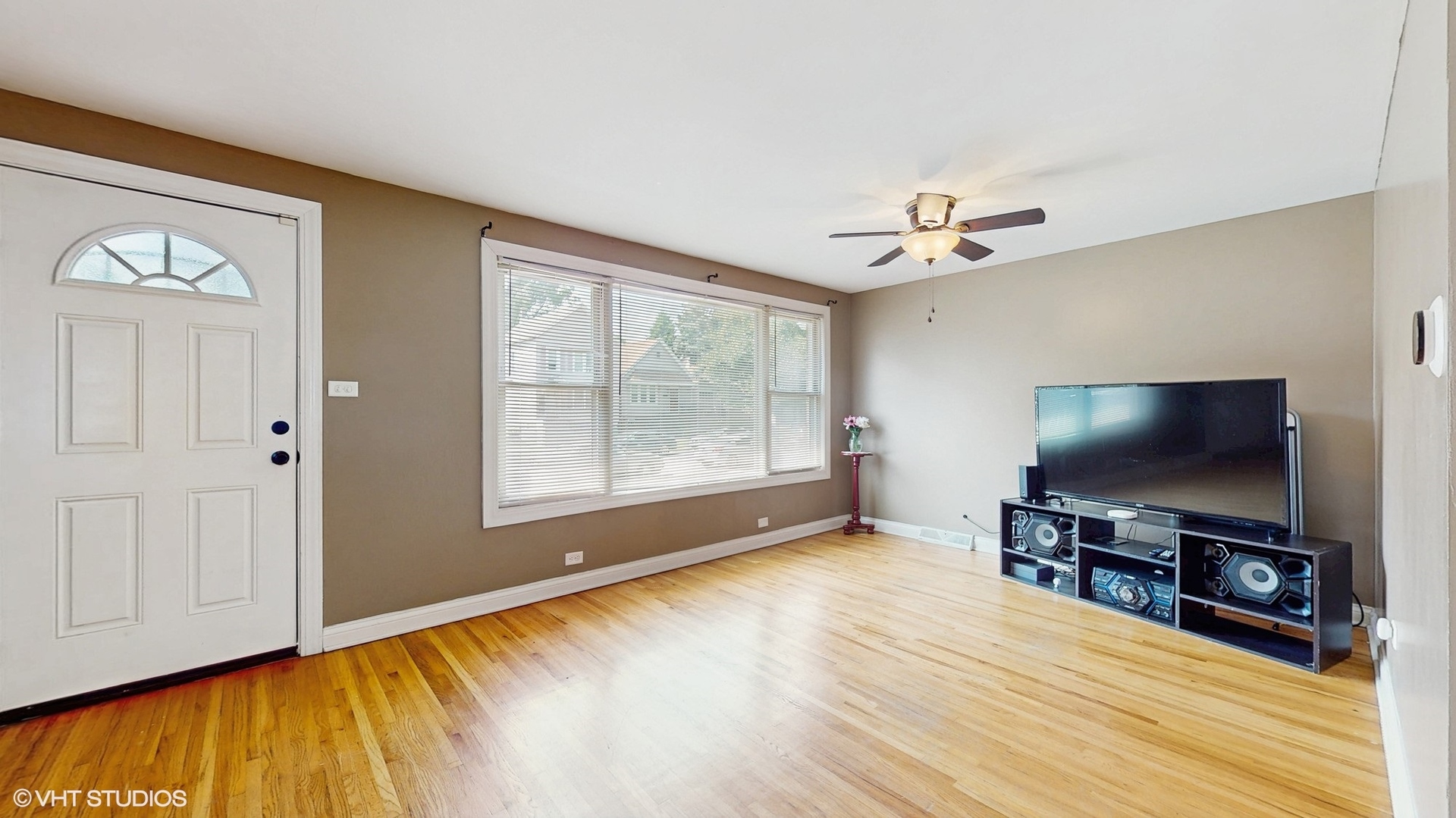 3052 East 97th Street Chicago, IL 60617 - Photo 2 of 19 a living room with furniture and a flat screen tv