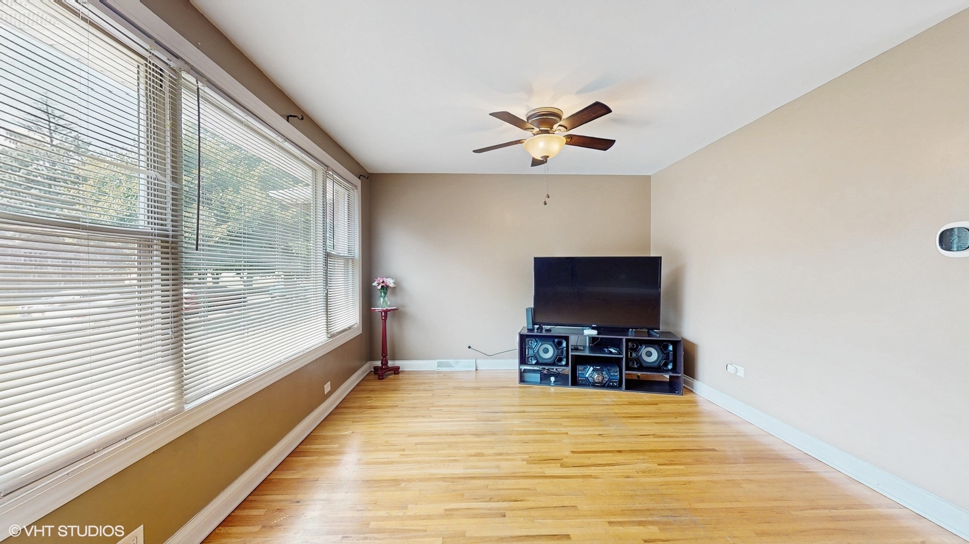 3052 East 97th Street Chicago, IL 60617 - Photo 3 of 19 a living room with furniture and a flat screen tv
