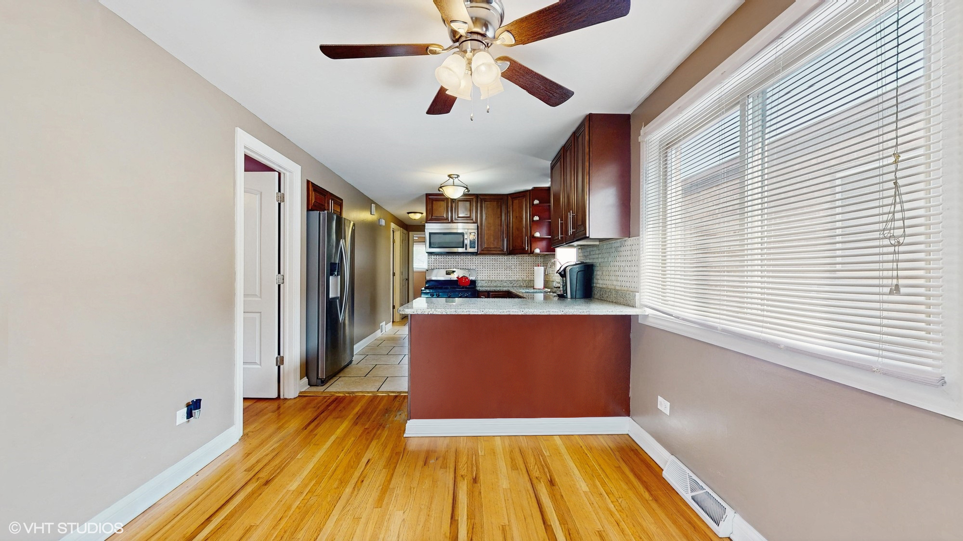 3052 East 97th Street Chicago, IL 60617 - Photo 5 of 19 a kitchen with stainless steel appliances granite countertop a refrigerator and a sink