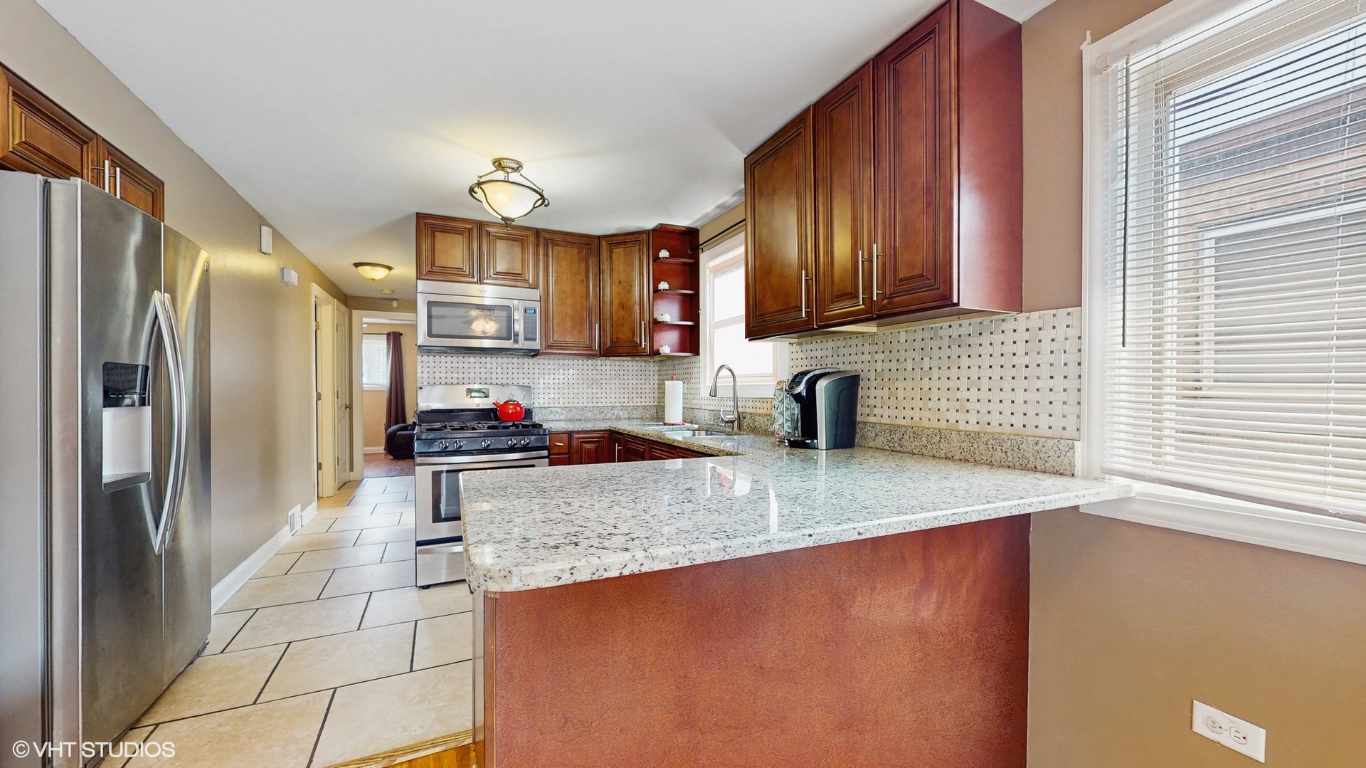 3052 East 97th Street Chicago, IL 60617 - Photo 7 of 19 a kitchen with stainless steel appliances granite countertop a sink stove and refrigerator