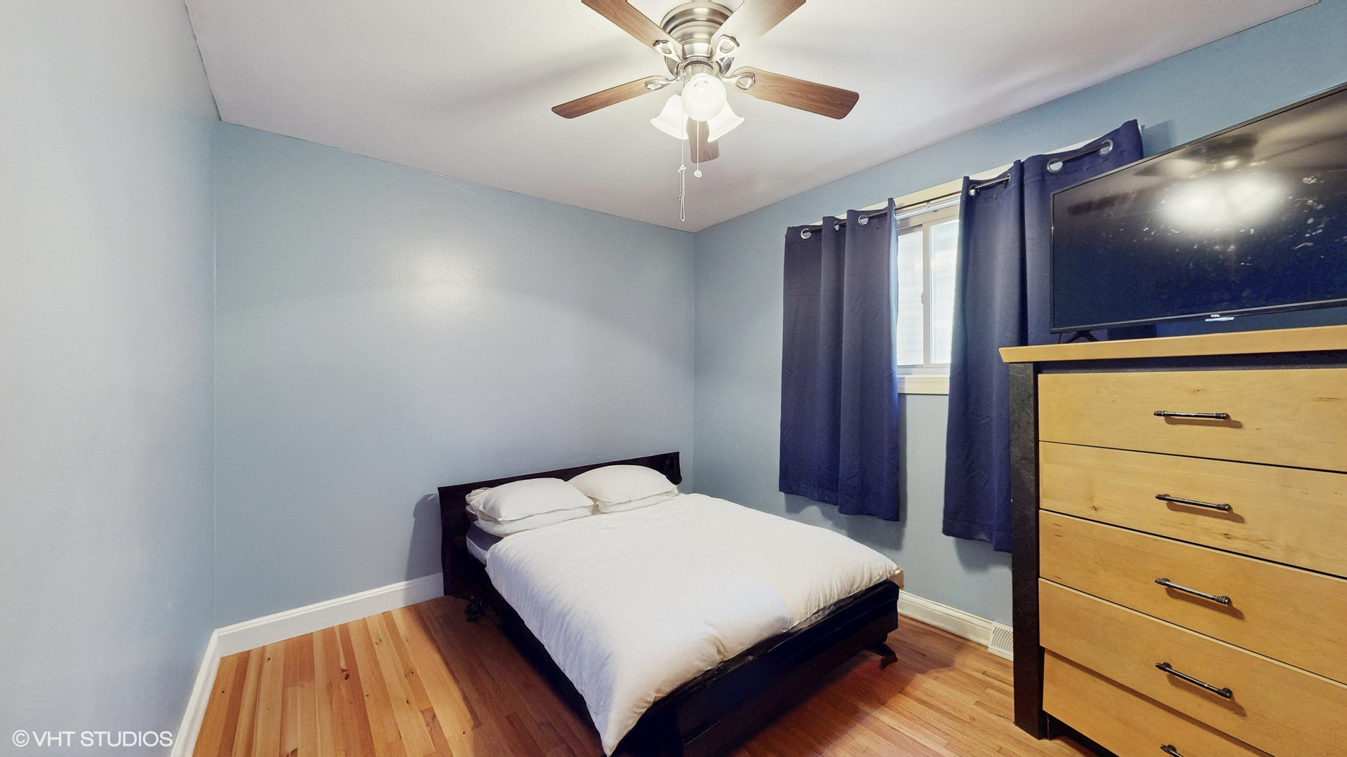 3052 East 97th Street Chicago, IL 60617 - Photo 9 of 19 a bedroom with a bed and a flat screen tv