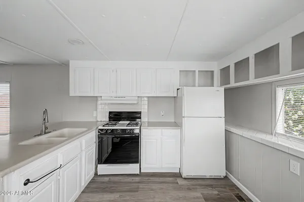 a kitchen with a sink stove and cabinets
