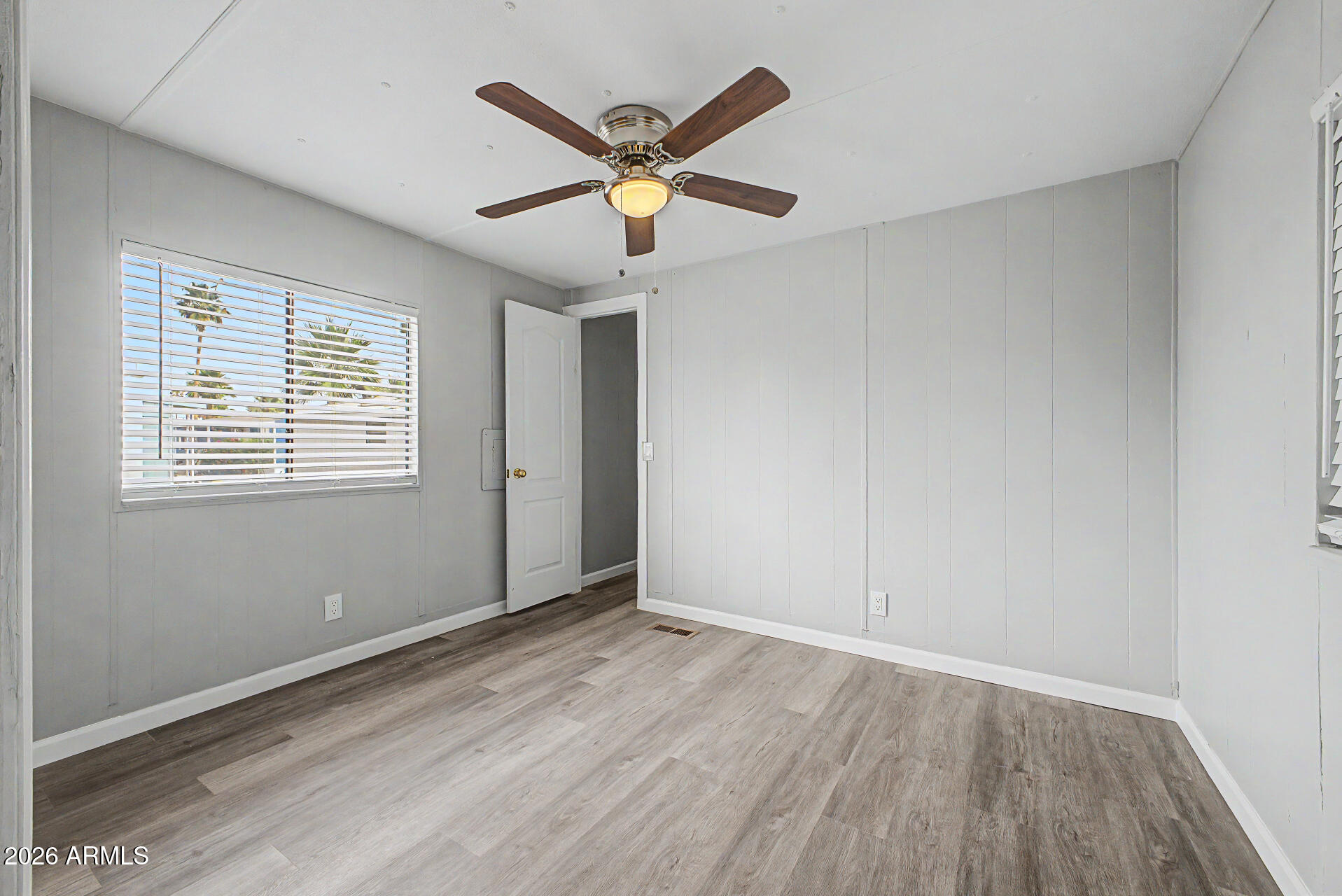555 West Warner Road, Unit 45 Chandler, AZ 85225 - Photo 14 of 22 a view of an empty room with wooden floor and a window