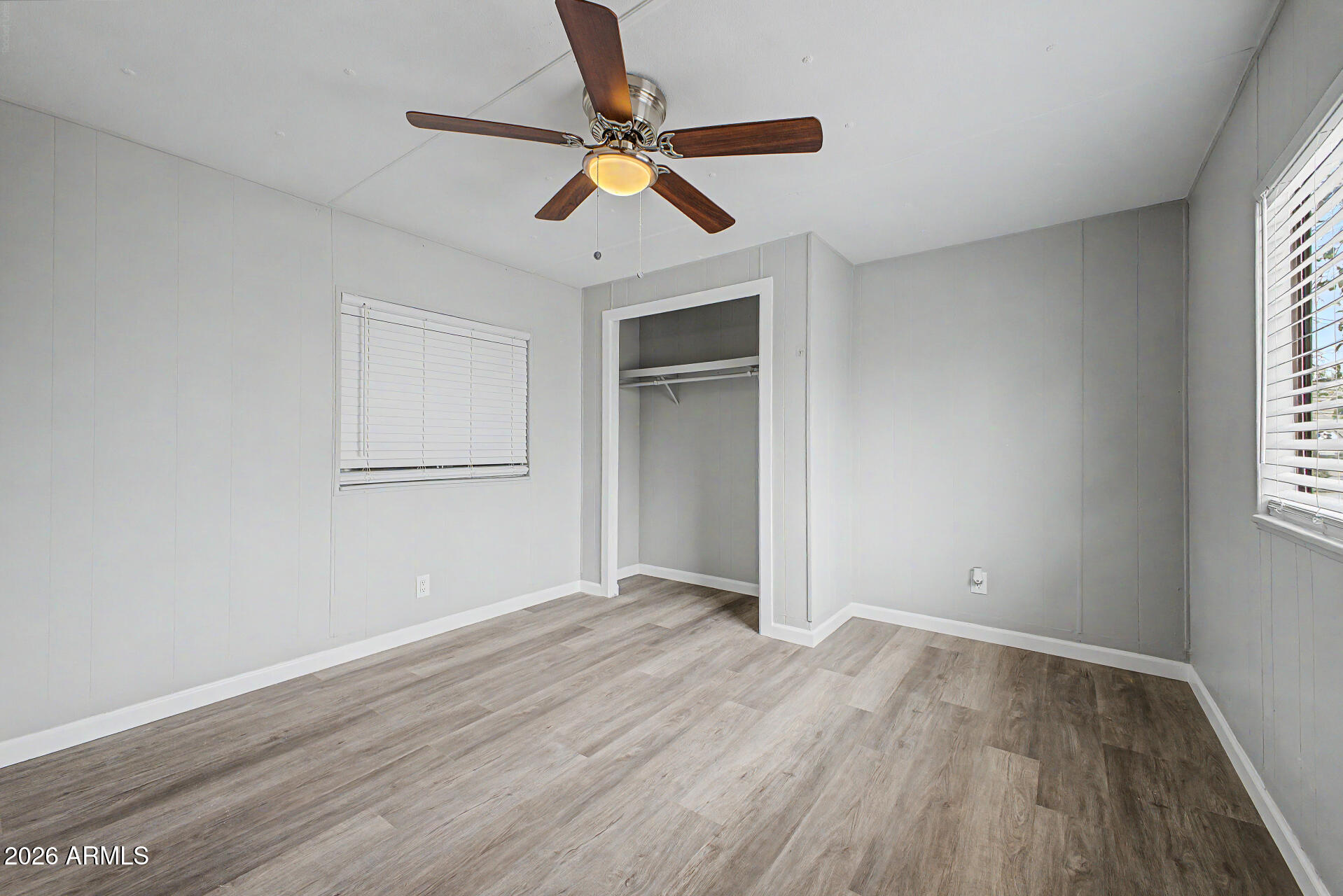 555 West Warner Road, Unit 45 Chandler, AZ 85225 - Photo 19 of 22 an empty room with wooden floor ceiling fan and windows
