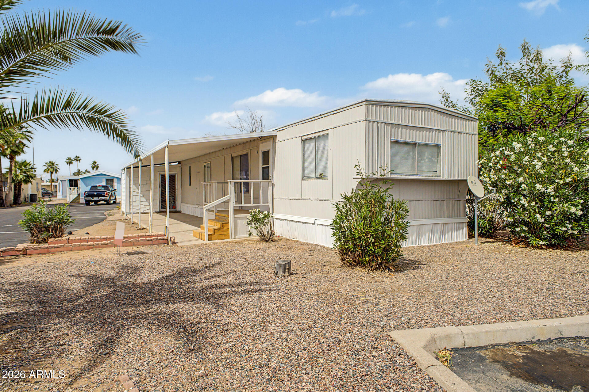 555 West Warner Road, Unit 45 Chandler, AZ 85225 - Photo 3 of 22 a front view of a house with a yard and garage