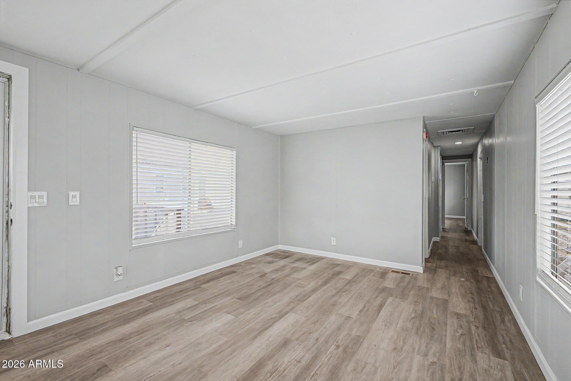 555 West Warner Road, Unit 45 Chandler, AZ 85225 - Photo 6 of 22 an empty room with wooden floor and windows