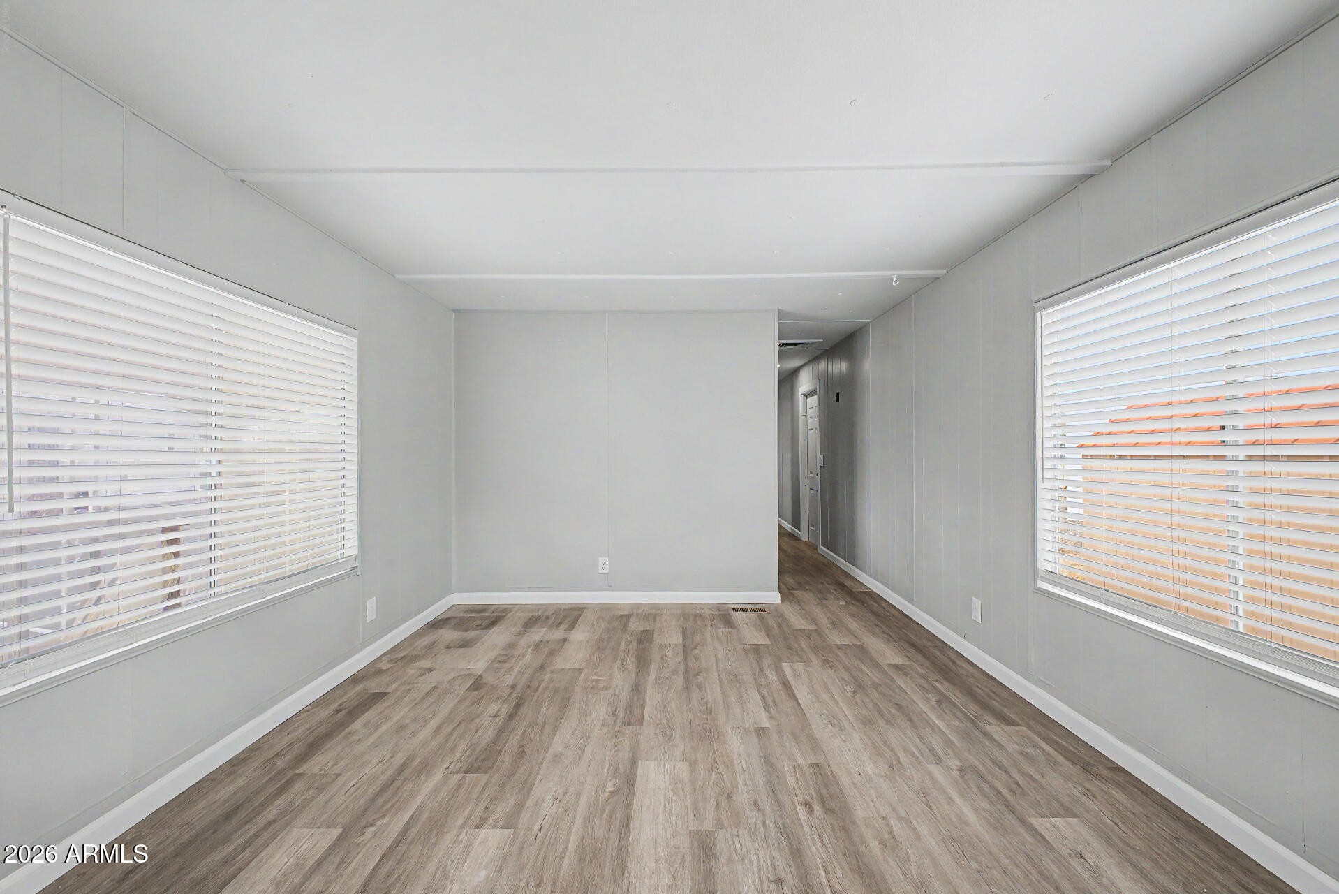 555 West Warner Road, Unit 45 Chandler, AZ 85225 - Photo 7 of 22 an empty room with wooden floor and windows