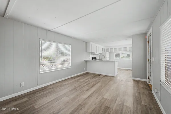 a kitchen with sink cabinets and wooden floor