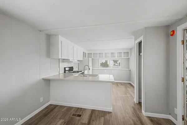 a kitchen with a sink a stove and cabinets