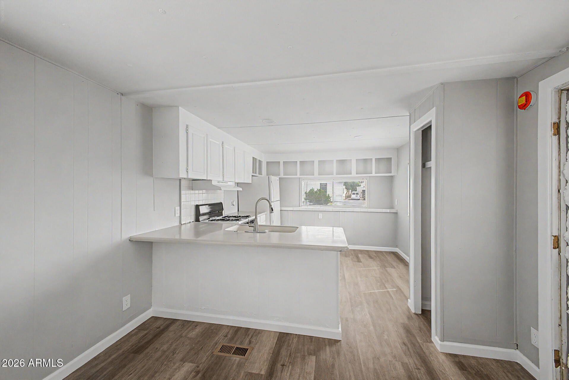 555 West Warner Road, Unit 45 Chandler, AZ 85225 - Photo 9 of 22 a kitchen with sink cabinets and wooden floor