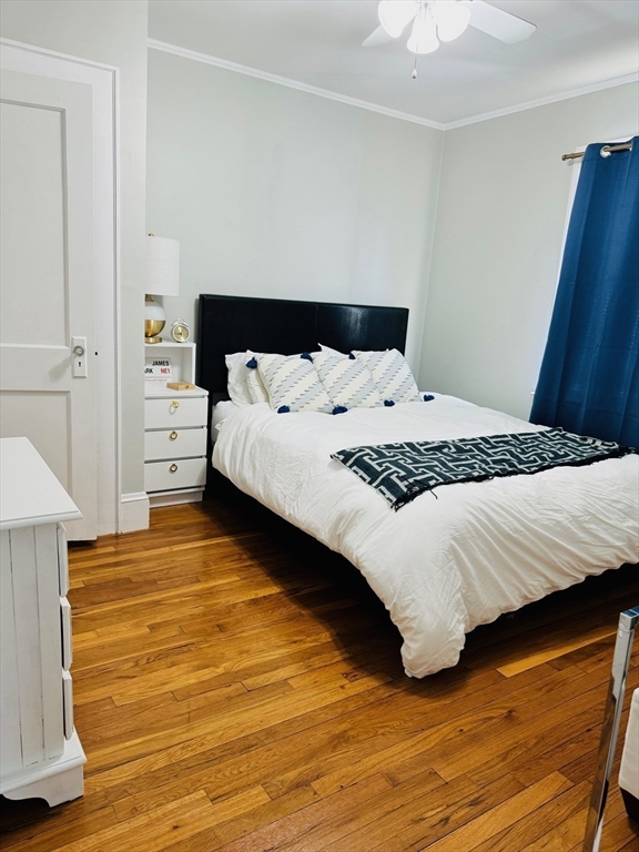 43 Chapman Street, Unit 2 Watertown, MA 02472 - Photo 8 of 12 a bedroom with a bed and a walk in closet