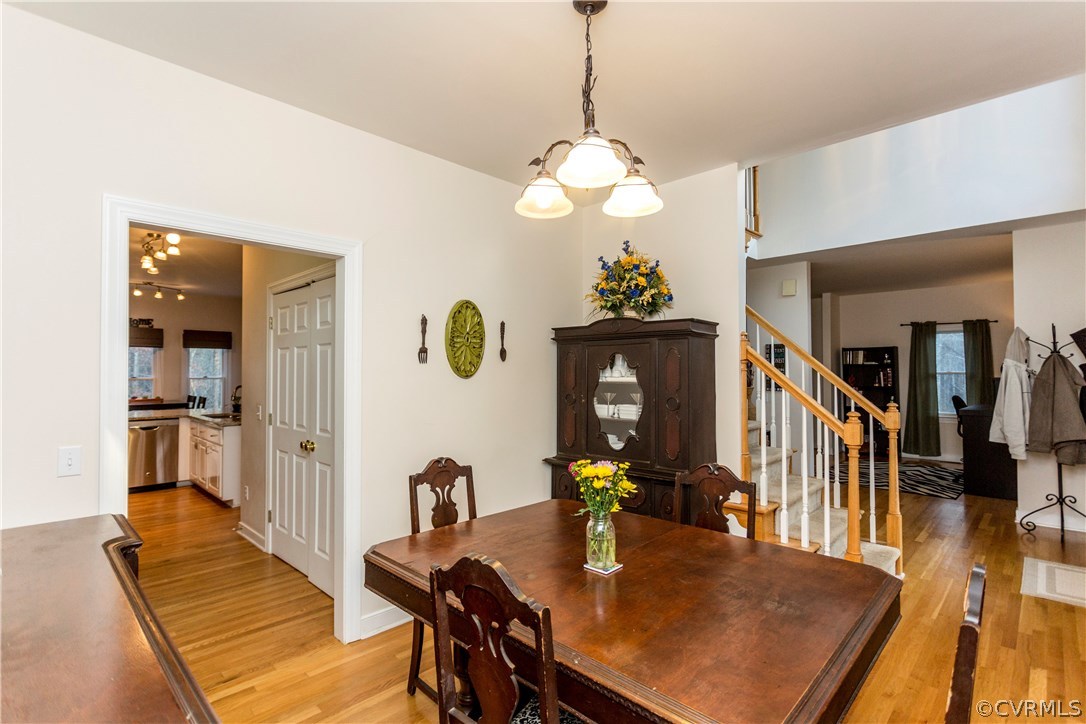 10201 Taylor Road Chesterfield, VA 23838 - Photo 11 of 50 a view of a dining room with furniture a chandelier and wooden floor