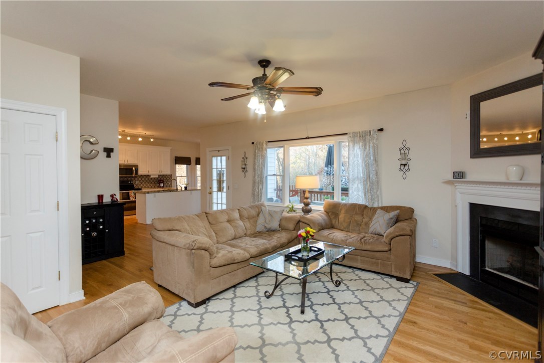 10201 Taylor Road Chesterfield, VA 23838 - Photo 17 of 50 a living room with furniture a fireplace and a flat screen tv