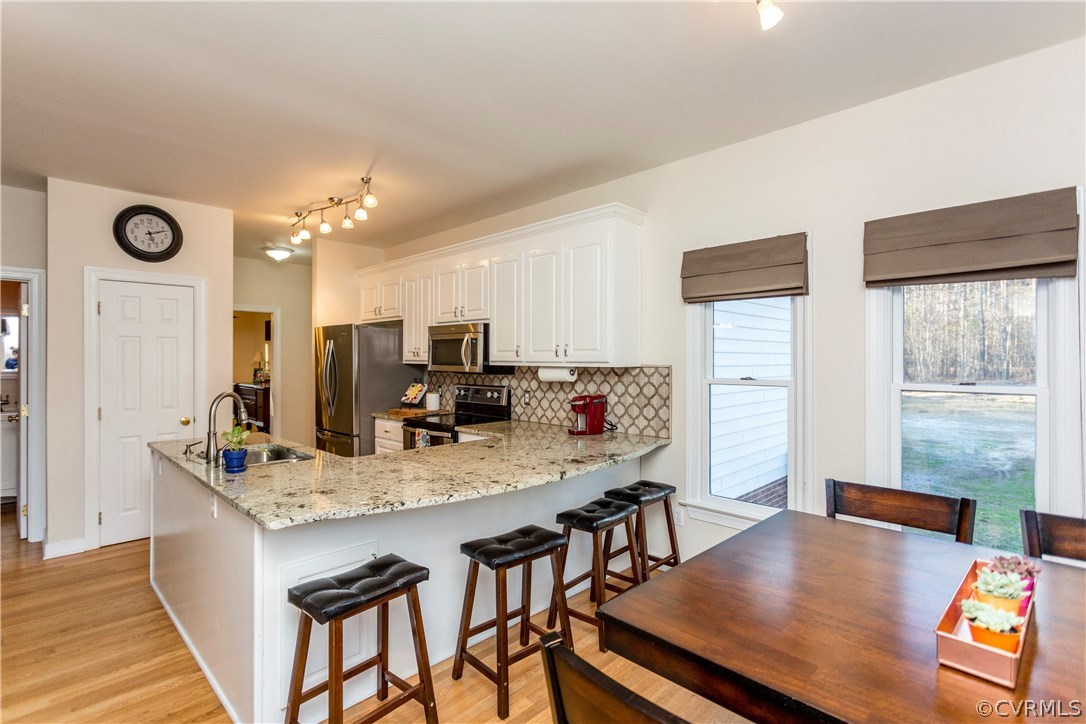 10201 Taylor Road Chesterfield, VA 23838 - Photo 3 of 50 a view of kitchen island a sink wooden floor dining table and chairs