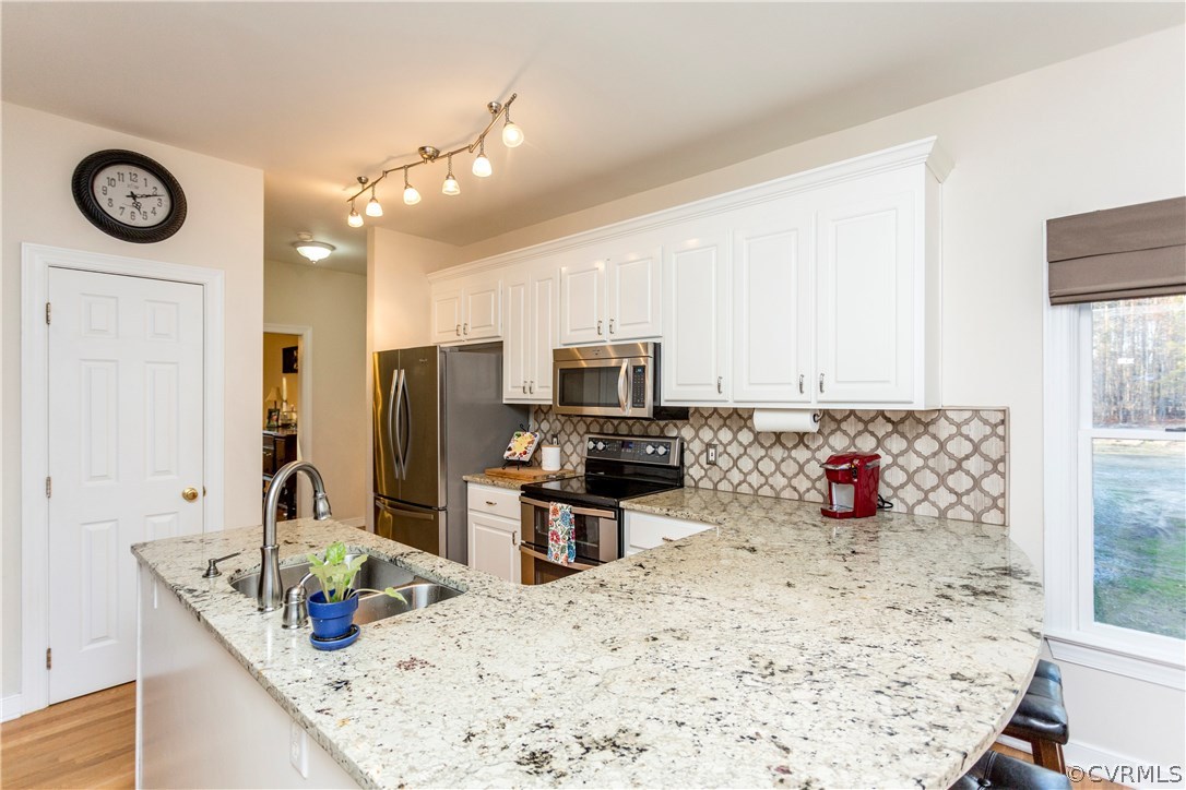 10201 Taylor Road Chesterfield, VA 23838 - Photo 6 of 50 a kitchen with a stove a refrigerator and a sink