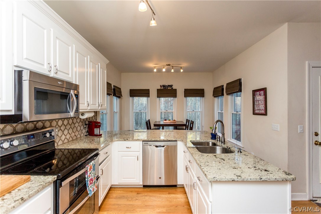 10201 Taylor Road Chesterfield, VA 23838 - Photo 7 of 50 a kitchen with stainless steel appliances granite countertop a stove sink and cabinets