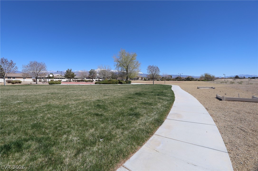 6472 Centennial Road Pahrump, NV 89048 - Photo 27 of 29 A sprawling green space with a paved walking path, perfect for outdoor activities.