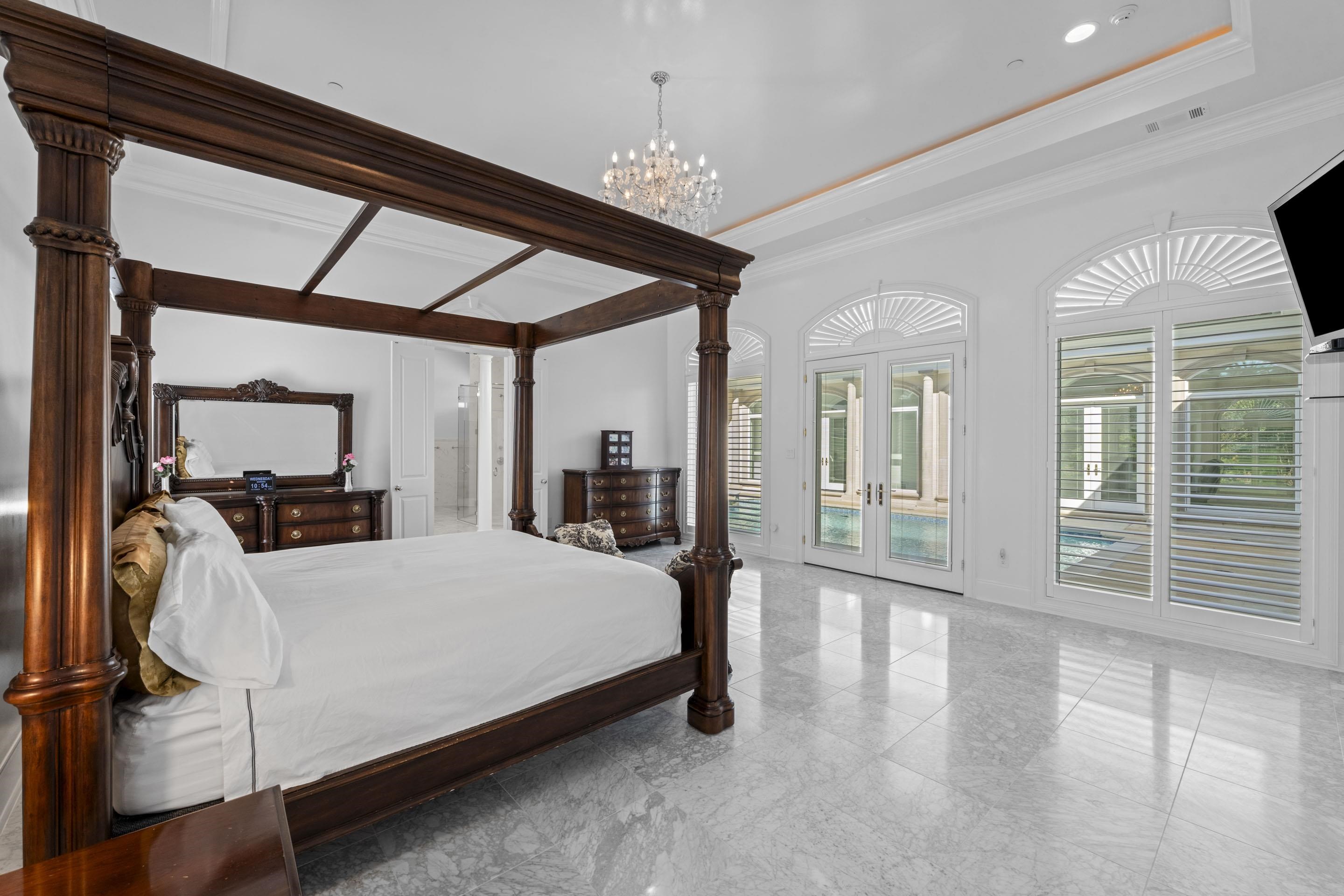 881 Bray Station Road Collierville, TN 38017 - Photo 20 of 40 Bedroom with french doors, access to exterior, a chandelier, ensuite bathroom, and crown molding