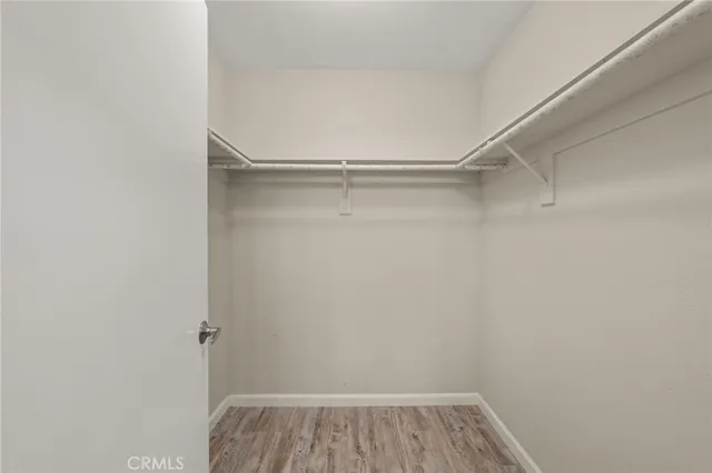 a view of walk in closet with clothes