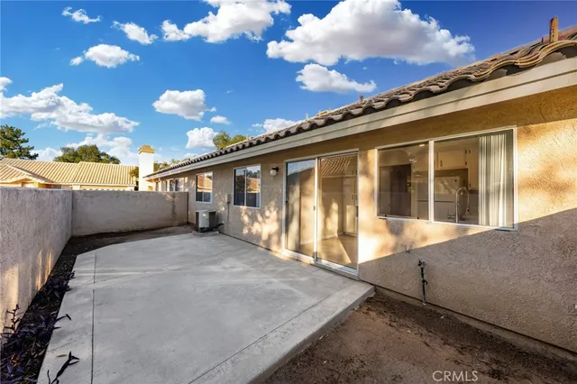 a view of a house with a large window and floor to ceiling window