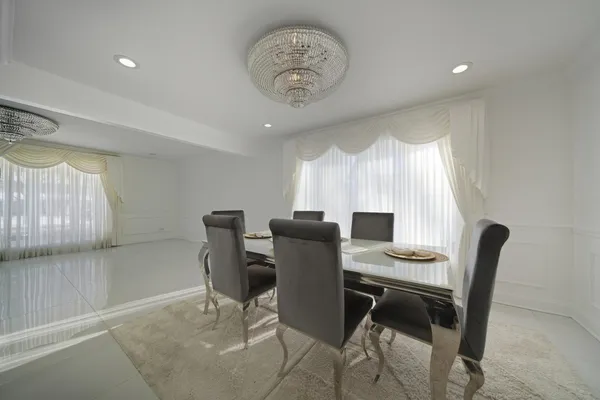 a view of a dining room with furniture and a window