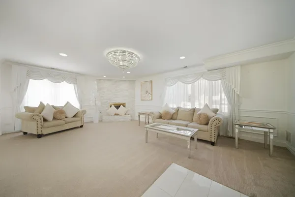 a living room with furniture and a chandelier