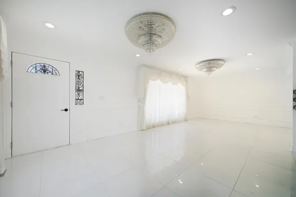 a view of a hallway with a chandelier fan