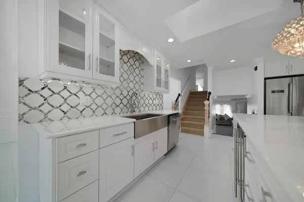 a kitchen with white cabinets and a sink