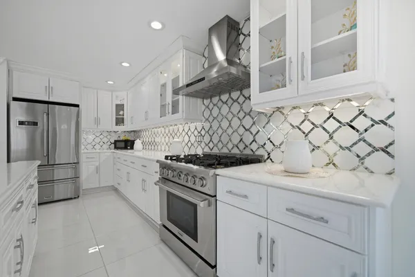 a kitchen with stainless steel appliances granite countertop a sink stove and refrigerator