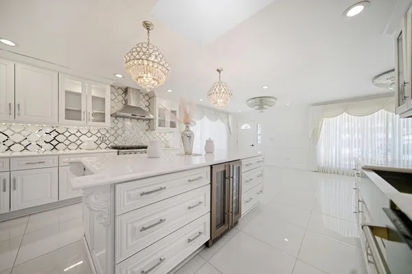 a spacious bathroom with a granite countertop sink a large mirror and a shower