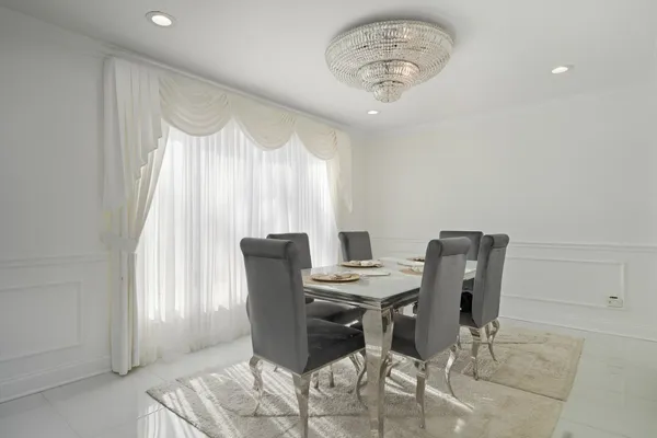 a view of a dining room with furniture and a window