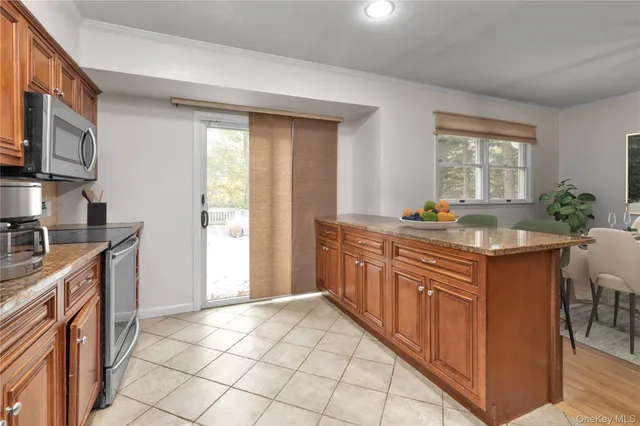 a kitchen with stainless steel appliances granite countertop a sink and a stove