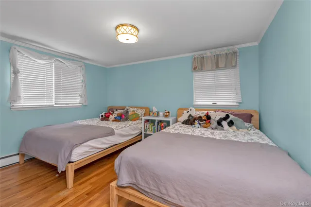 a bedroom with two beds and a window