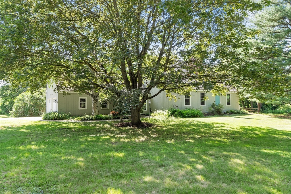 4 Prospect Hill Road Harvard, MA 01451 - Photo 30 of 37 a house that is sitting in the grass with large trees