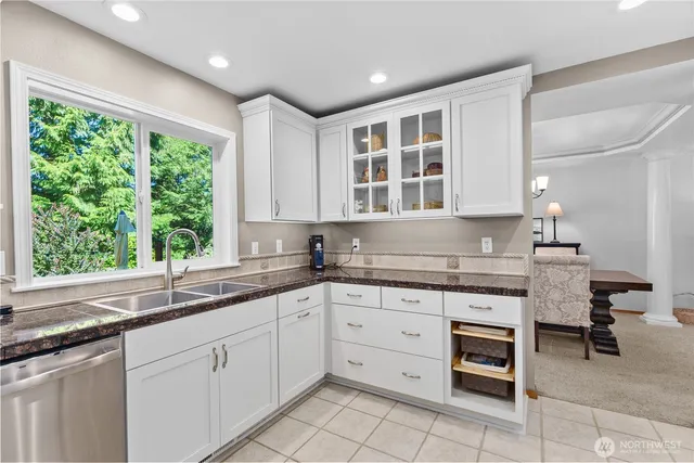 a kitchen with a sink window and cabinets