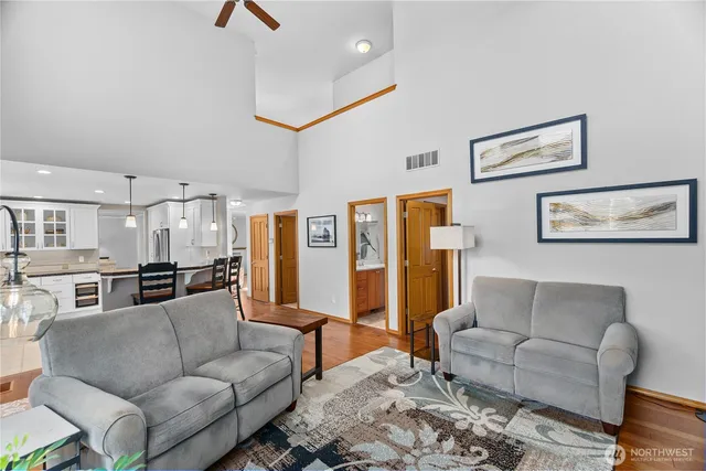 a living room with furniture and a kitchen