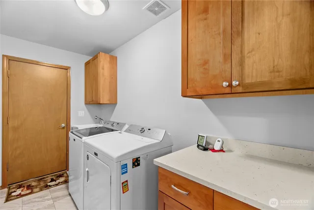 a utility room with sink dryer and washer