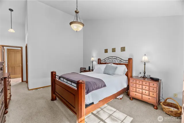 a bedroom with a bed and a night stand