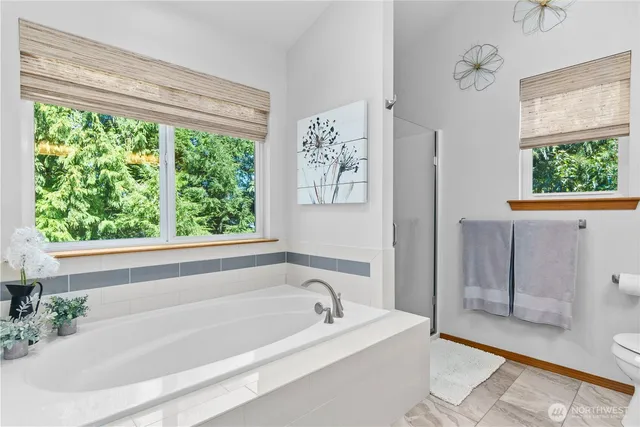 a bathroom with a bathtub and a shower