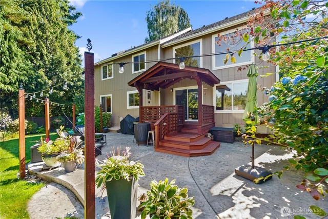 a front view of a house with a yard balcony and outdoor seating