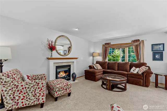 a living room with furniture fireplace and a window
